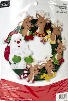 a christmas wreath with reindeers and santa claus