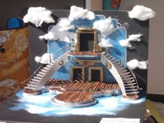 a paper model of a house with stairs and clouds