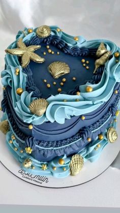 a blue and gold decorated cake on a white plate