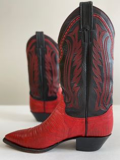 Tegu lizard and leather cowboy boots with a walking heel and dressy snip-toe. The black leather shaft is smooth, slightly textured, and beautifully embroidered in red. Leather soles and stacked leather heels. Justin is a high-quality bootmaker: these are sturdy and welted for a lifetime of resoling. Made in U. S.A.Size: 6. 5 (women) / 5 (men)Shaft: 11”Heel: 1. 5”Heel to toe: 10. 25”The toe box, across widest point: 3. 25”Condition: excellent, regular scuffing and wear on the bottomNeed to know: All boots have been cleaned, conditioned, and polished with material-specific products as needed; boots, especially exotic skins, have the best longevity when cared for by a cobbler. from the 70s or 80s. 80s Boots, Tegu Lizard, Best Cowboy Boots, 70s Boots, Snakeskin Cowboy Boots, Pirate Boots, Custom Cowboy Boots, Silverado Truck, Red Cowboy Boots