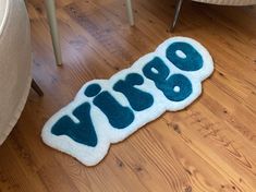 a dog laying on the floor in front of a rug that says paws