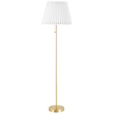 a gold floor lamp with a white shade