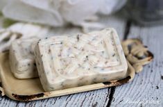 two soap bars sitting on top of a wooden tray