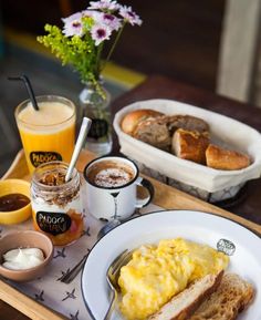 a breakfast tray with eggs, toast, and coffee on it is ready to be eaten