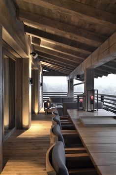 the inside of a building with wooden flooring and stairs leading up to an upper level