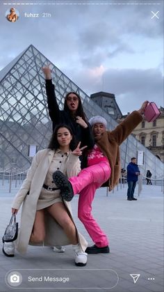 three women posing for a photo in front of the pyramid