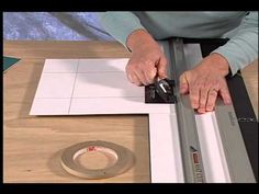 a person using a table saw to cut paper