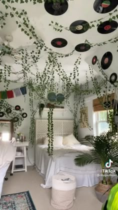 the room is decorated with plants and vinyl records on the ceiling, along with other decorations