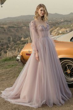 Arrive to any event looking like you stepped right out of a dream in the Fairy Tale Lilac Long Sleeve Tulle Maxi Dress! Elegant tulle shapes this stunning dress featuring a sweetheart neckline, sheer long puff sleeves and textured flowers along the shoulder line and neckline. Bustier bodice with hidden boning and padded cups tops a high fitted waist followed by a cascading maxi skirt. Open back with lace tie up for perfect fit.   Handmade-To-Order  Tulle & Polyester.  Lined.  Runs true to size.  Hand Wash Cold. Do Not Bleach. Line Dry. Iron Low Heat.    ** This dress is Made-To-Order. Whether you choose a standard size or custom measurements, each dress is uniquely handmade by our master tailors to order. Product color may vary due to lighting on images and screen resolution.  * For Cu Elegant Ball Dresses, Gaun Tulle, Long Prom Dresses