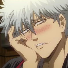 an anime character with white hair holding his hand to his face