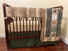 a baby crib with a blanket on top of it and an animal themed bedding