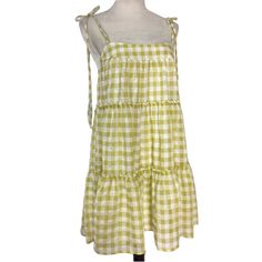 Get Ready To Turn Heads With This Stunning Altar'd State Gingham Tiered Mini Sundress, Perfect For Any Occasion! Featuring A Square Neckline With Strappy Sleeves And A Tie Closure, This Colorful Dress Is Made Of High-Quality Polyester Fabric And Is Fully Lined. The Layered Accents And Short Dress Length Add A Touch Of Boho Vibes, Making It A Great Choice For Summer, Fall, And Spring. This Dress Is Sized As Small And Is Crafted For Women Who Love To Express Their Unique Style. Don't Miss Out On T Green Cotton Mini Dress For Picnic, Picnic Gingham Sundress With Ruffles, Summer Plaid Dress With Tie Straps, Plaid Summer Dress With Tie Straps, Plaid Sundress For Vacation, Sleeveless Gingham Dress With Tie Back, Gingham Cotton Mini Dress For Beach, Gingham Cotton Mini Dress For The Beach, Plaid Sundress Mini Dress For Vacation