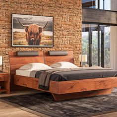 a bedroom with a brick wall and a bed in the middle that has a cow head on it