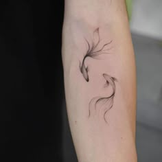 a woman's arm with a bird tattoo on it