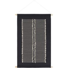 a black and white wall hanging on a wooden frame with strings attached to the side