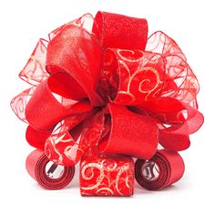 a red bow with gold swirls on it and two bells attached to the ribbon