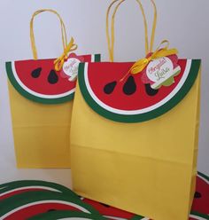 two watermelon bags sitting next to each other on top of green and yellow plates