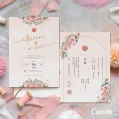 the wedding stationery is laid out on top of pink and white flowers, with gold foil lettering