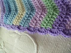 there is a crocheted blanket that looks like it has been made with yarn