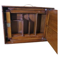 an old wooden cabinet with doors open on the inside and drawers closed to reveal items