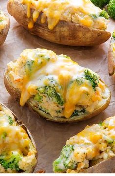 baked potatoes with broccoli and cheese on them sitting on a baking sheet, ready to be eaten