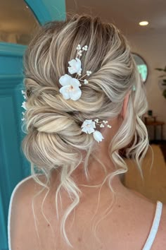 a woman with blonde hair and flowers in her hair