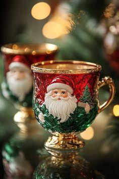 two christmas mugs sitting next to each other on a table