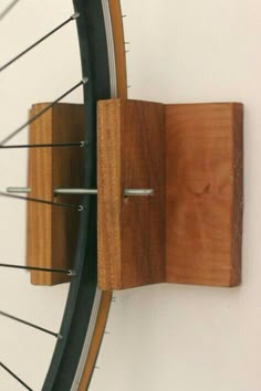 a close up of a bike tire and spokes on a wall mounted bicycle rack