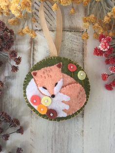 a felt ornament with a fox on it