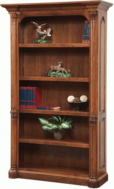 a wooden bookcase with three shelves filled with books and figurines on top