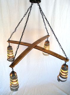 a chandelier made out of wooden planks with lights hanging from the bottom