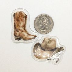 two pieces of glass with an image of a cowboy's boot and a quarter penny