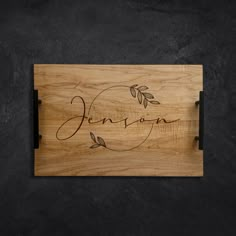 personalized cutting board with leaves and name engraved on the front, shown from above