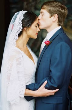 a bride and groom are kissing each other