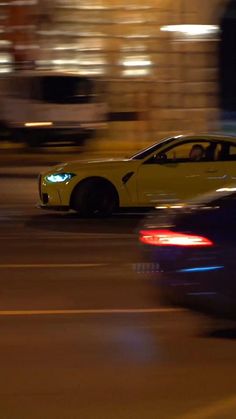 a car driving down the street at night time with blurry lights on it's sides