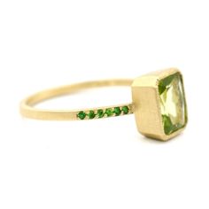 Your heart will sing everytime you look at the fresh green hue of this statement ring! The potential of spring blossoms within you as the peridot flashes sparkles of green in your eyes. Known as the stone of compassion, peridot is believed to bring good health, restful sleep and peace to relationships by balancing emotions and mind. This friendly bright green stone also has the uncanny ability to inspire eloquence and creativity. This 14k gold ring features an 8x6mm fancy emerald cut peridot, ac Balancing Emotions, Spring Blossoms, Gold Bullion, August Birthstone, Perfect Birthday Gift, Pave Ring, Restful Sleep, Fresh Green, 14k Gold Ring