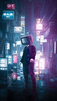 a man with a tv on his head standing in the middle of a city at night