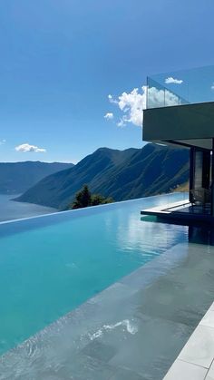 an empty swimming pool with mountains in the background