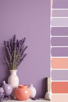 some vases with flowers in them are sitting on a shelf next to a purple wall