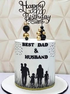 a birthday cake with the words best dad and husband on it, decorated with black and gold decorations