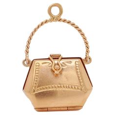 A fine vintage figural purse charm or pendant. In 18k gold (with a light rose gold hue). In the form of a purse or lady's handbag that opens with a hinge to the base and a snap closure that closes tightly. Supported on a rope-twist, swing handle bail allows this to be worn as a large charm in a charm bracelet or fixed with a jump ring to wear as a pendant necklace. Marked to the bail with an assay mark. Simply a wonderful high-level charm! Date: 20th Century Overall Condition: It is in overall good, as-pictured, used estate condition with some fine & light surface scratches and other signs of expected light wear consistent with age. Fineness: Unmarked for gold fineness. Professionally tests at 18k. Marks: Marked to the top of the bail with an assay mark. Measurements: Width: ca. 21 mm Heig Gold Boots, Vintage Pendant Necklace, Turquoise Charm, Rope Twist, Light Rose, Cross Charms, Purse Charms, Metal Charm, Shoe Charms