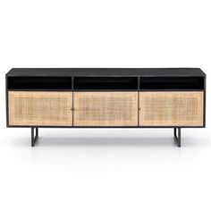 the sideboard is made from rattan and black wood