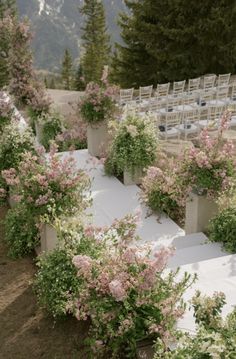 an outdoor ceremony setup with flowers and chairs