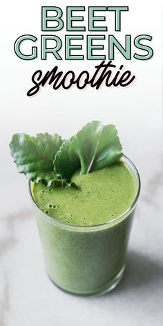 a green smoothie is in a glass with leaves on top and the words beet greens smoothie above it