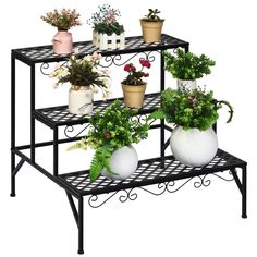 three tiered plant stand with potted plants on top and bottom shelf holding pots