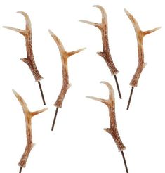 four sticks that have some kind of animal like thing on them