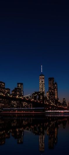 the city skyline is lit up at night