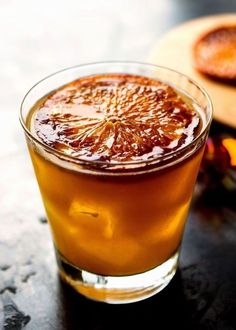 a glass filled with liquid sitting on top of a table