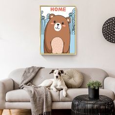 a brown bear sitting on top of a couch in a living room