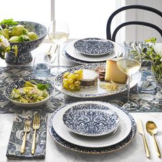 the table is set with blue and white dishes